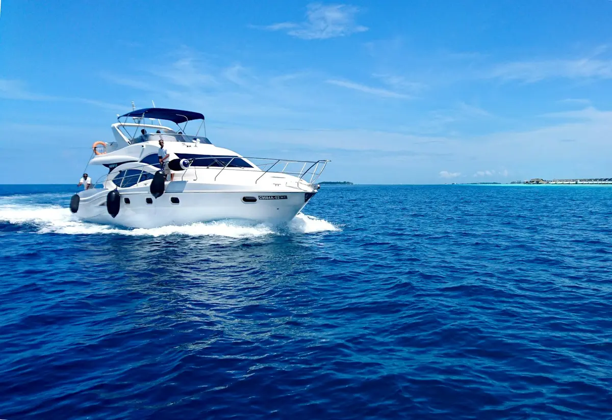 Private boat cutting through blue water